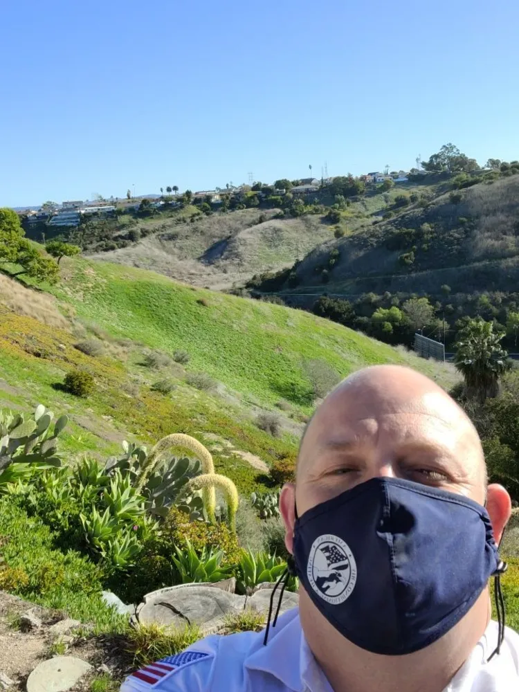 american air hvac tec wearing a safety mask out in nature