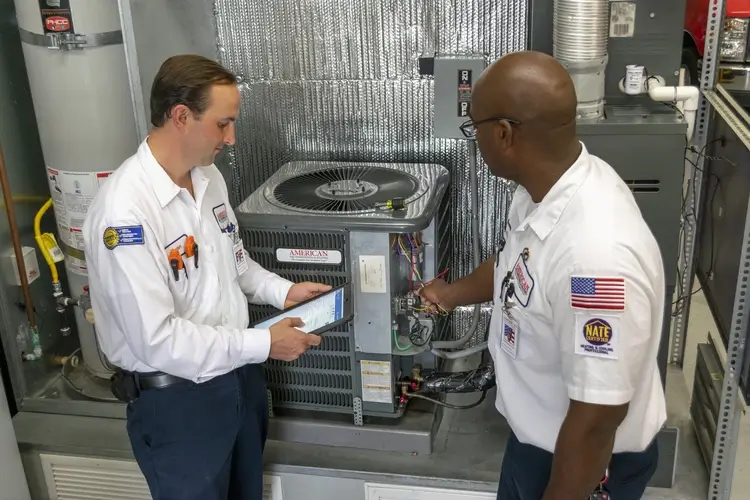 AAC Technicians inspecting an air conditioner