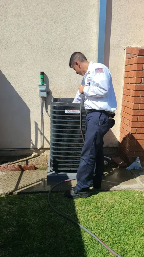 HVAC technician inspecting an air conditioner